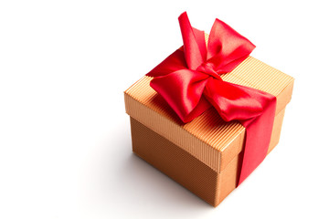 gold gift with the red ribbon isolated on white background