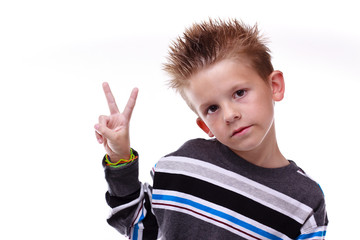 Cute young boy holding up the peace sign