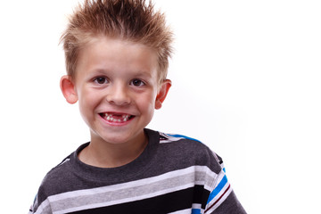 Cute young boy smiling and missing teeth