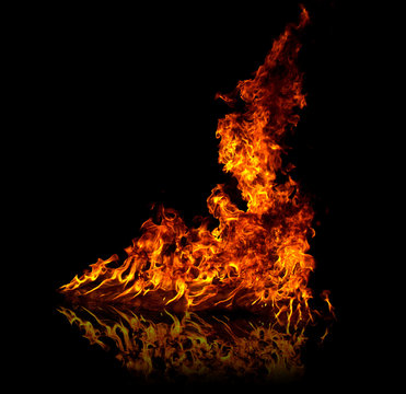 Fire with reflection on floor, isolated on black background