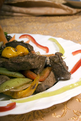 Fried juicy meat served with vegetables