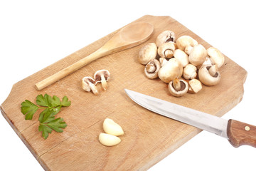 Fototapeta na wymiar Mushrooms, parsley and garlic on a wooden board