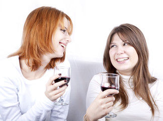 Two girlfriends with two glasses of wine.