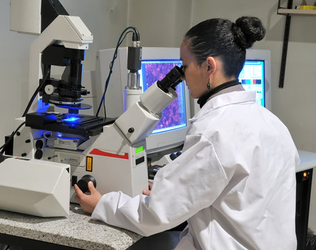 researcher working with fluorescent microscope