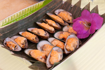 Cheese Topped Muscles on Banana Leaf Serving Mat