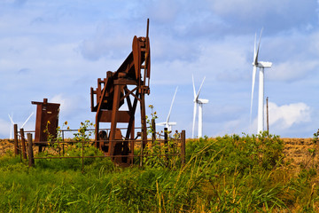 Fototapeta na wymiar Wind gerators and oil wells