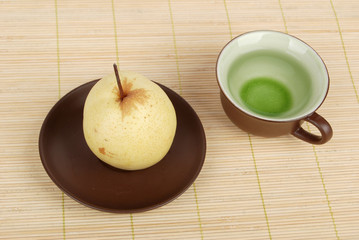 A pear with tea on bamboo