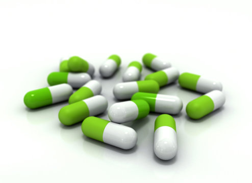 Green medical pills on white background