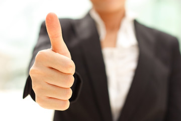 Business woman shows thumb up