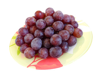 Red grapes on a plate. Isolation