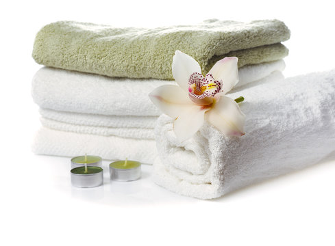 stack of  towels with  orchid flower