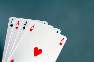 hand holding four aces