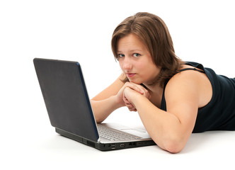 Fototapeta premium Woman working on a laptop isolated over a white background