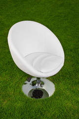 white design leather swivel chair on green grass
