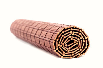 Obraz premium Rolled bamboo mat isolated on white background