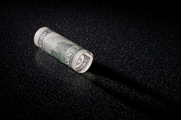 American 100 dollars greenback rolled like a lantern