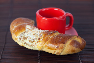Cup with a plate and roll on a bamboo mat