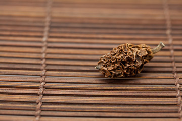 Obraz na płótnie Canvas Dried walnut on a bamboo mat
