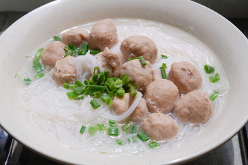 close up of meat ball soup with rice vermicelli