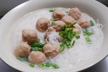 close up of meat ball soup with rice vermicelli
