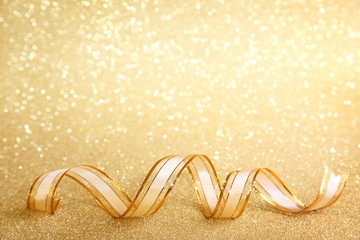 Golden festive background with ribbon