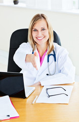 Joyful female doctor ready to shake hands with a patient