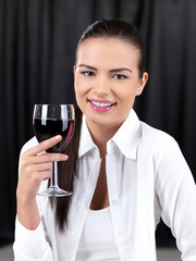Portrait of beautiful woman with glass of red wine