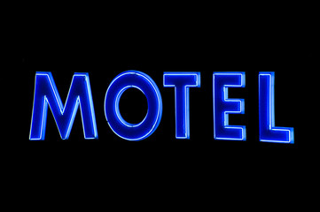 Blue Neon Motel sign at night, isolated
