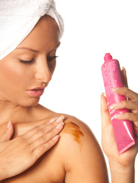 Woman applying fake tan