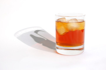 Whiskey glass with death in shadow