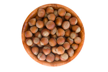 Hazelnut in round wooden plate. isolated on white