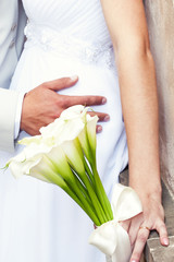 the bride and groom with a bouquet of flowers