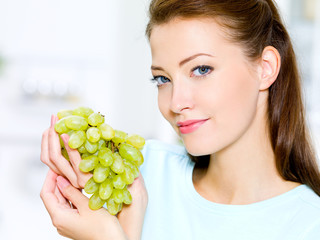 beautiful woman holds grapes