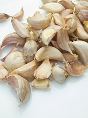 Pieces of raw garlic on the white table