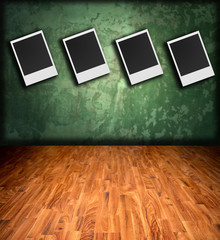 Old polaroid photos on antique backdrop .