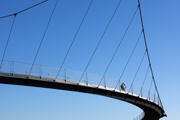 cyclist crossing a bridge