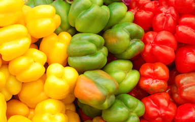 Obraz na płótnie Canvas close up of red, yellow and green peppers