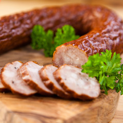 Closeup of dried sausage on rustic cutting board