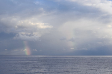 Naklejka na ściany i meble Black Sea landscape with rainbow and cloudy sky.