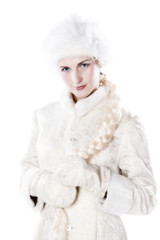 Beautiful girl in a white winter coat