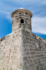 Fototapeta na wymiar Tower of an old castle with a beautiful blue sky background