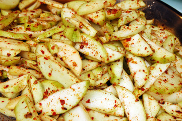 Young mango mixed with sugar and dry chilli
