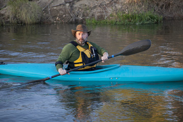 adult paddler in blue kayak