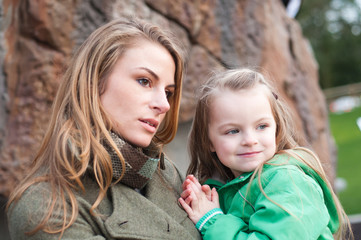 Mother holding toddler daughter