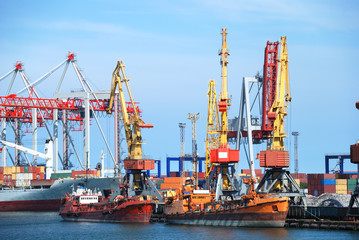 The trading seaport with cranes, cargoes and ship