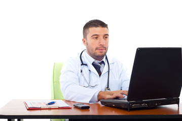 Confident doctor working on laptop
