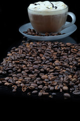 Pure glass with coffee with smoke and granules on black table