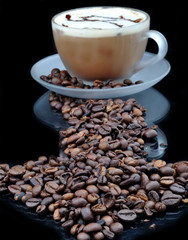 Pure glass with coffeeand granules on black table