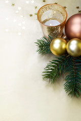 Christmas background with baubles, candle and pine branches.