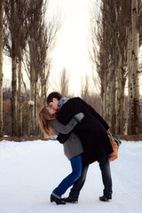 young couple kissing in the poplar alley